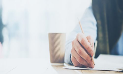 Businessman,Handing,Pencil,Hand,And,Writing,Message.,Blurred,Background,,Horizontal